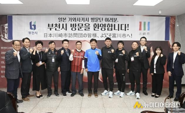 조용익 부천시장과 가와사키시 선수단, 부천시 관계자들이 단체 사진을 찍고 있다.