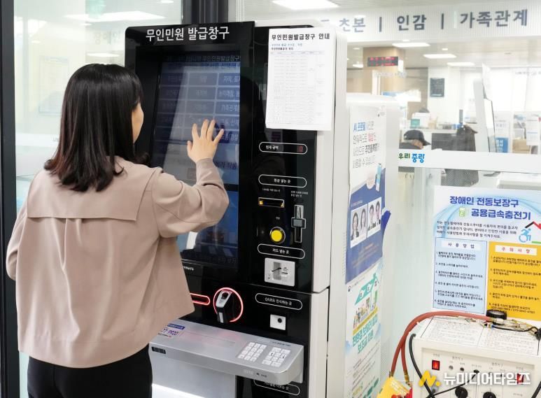 무인민원 발급창구를 이용하는 주민의 모습