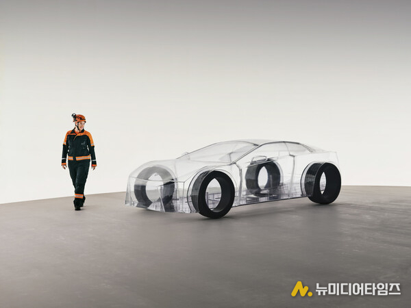 A dedicated Sandvik engineer walks around the eNimon, assessing the eNimon, which highlights the critical, often unseen, reliance on robust mining infrastructure to power the EV future.